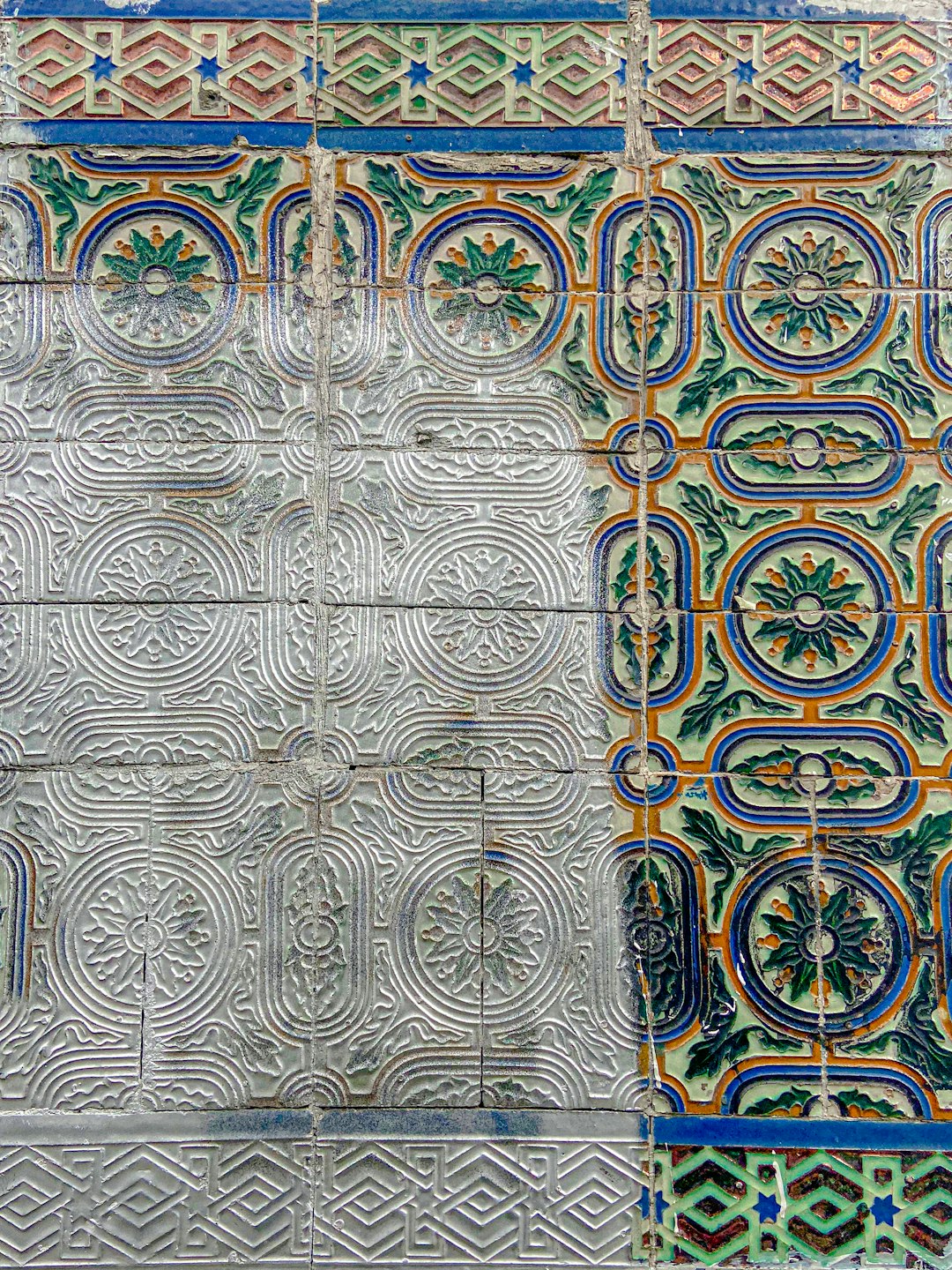 A closeup of the intricate patterns on an ancient tile wall, showcasing the beauty and complexity found in Islamic art. The colors include shades of blue, green, white, silver, yellow, orange and red. –ar 3:4