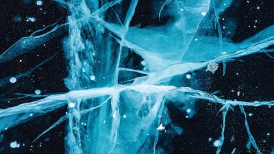 A digital art piece depicts an abstract ice surface with frozen blue and white branches set against the deep black background of space. The scene is captured from above in a closeup view, showcasing intricate details on each branch with delicate snowflakes scattered across it. This composition creates a sense of serene beauty within interstellar chaos.