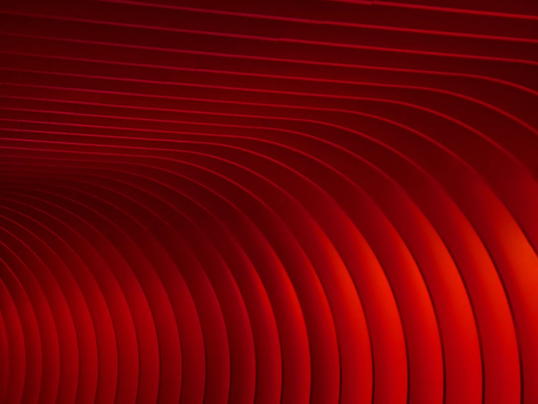 Red background, red gradient lines, curved shapes, minimalist style, high-end texture, high resolution, high detail, best quality, best lighting, perfect composition, symmetrical layout, symmetrical structure, and a strong sense of space. The entire screen is covered with red thin curves, creating an overall red color scheme. This abstract background can be used as the cover for product launch banners or marketing materials, adding visual impact to your products. The style is in the minimalist style. –ar 4:3