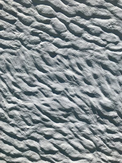 white sand texture, with small wave patterns, top view, hyper realistic photography --ar 3:4