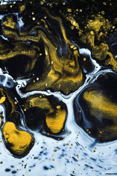 Black and gold ink swirls with a white background in an abstract painting. Golden glitter sits on the surface of water in the style of flowing waves, with yellow particles floating in the sea against a black background in an ink art style using ink dots with bright colors, high contrast, and cool tones at a high resolution. --ar 85:128