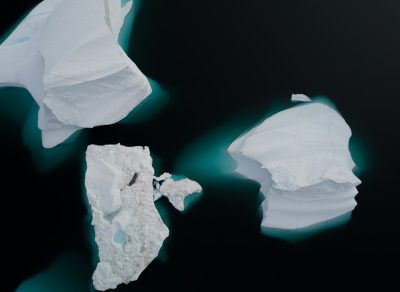 Aerial view of melting icebergs in the Greenland Sea, drone photography, minimalist, black background, high resolution, high detail, hyper realistic in the style of minimalist. --ar 128:93