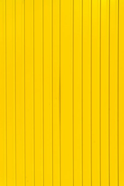 A bright yellow metal wall with vertical lines as background or texture. --ar 85:128