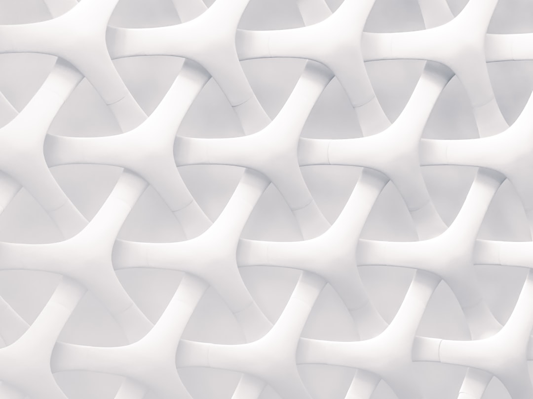 3d render of white abstract background with interwoven curves and arches. The pattern is made from thin, intertwined lines that create an intricate design. It has a modern aesthetic with soft lighting that highlights the contours of each curve. –ar 4:3