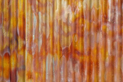 A closeup of an old, rusted corrugated iron wall with a vibrant orange and brown color gradient, creating intricate patterns and textures that add depth to the background. The texture is detailed, adding visual interest to your design projects. High resolution photography. There is empty blank space in the center. --ar 128:85