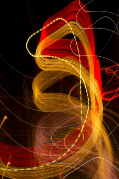 red and yellow light painting, long exposure photography, black background, bokeh effect, abstract lines, curves, red and gold, vibrant, vivid colors, --ar 85:128