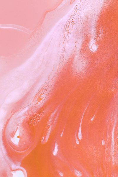 Close up of pink and orange milk, abstract photography in the style of minimalist, surrealistic, pastel tones, close up --ar 85:128