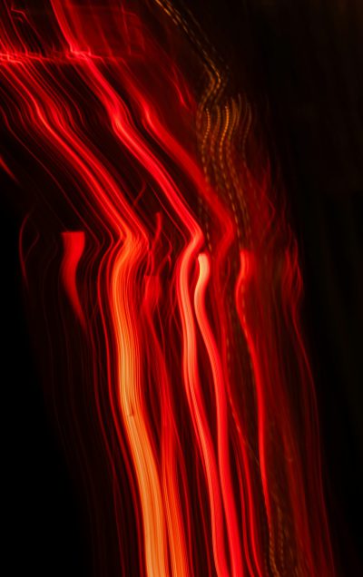 red and orange light streaks on black background, long exposure photography, blurred imagery, dark art style, atmospheric lighting, ambient lights, red flames --ar 5:8