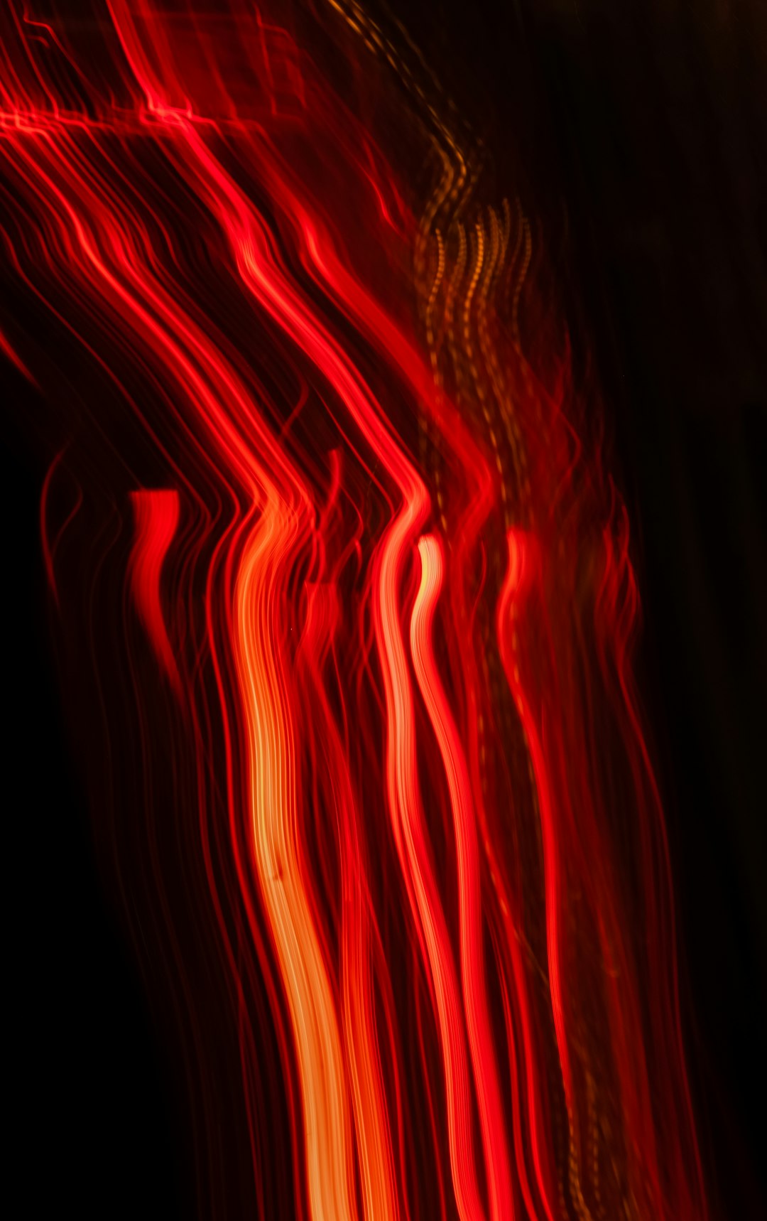 red and orange light streaks on black background, long exposure photography, blurred imagery, dark art style, atmospheric lighting, ambient lights, red flames –ar 5:8