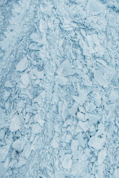 photograph of ice and snow texture, top view, flat lay, light blue color palette --ar 85:128