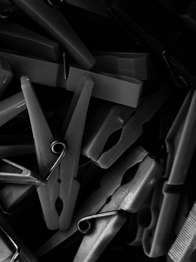 black and white photo of clips, dark background, high resolution, high contrast, depth of field, shot in the style of Sony Alpha A7 III --ar 3:4