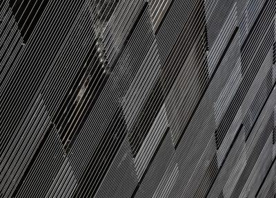 A highresolution texture of a black metal wall with diagonal lines, capturing the industrial look and creating an atmosphere of modernity and sophistication. The detailed lines add depth to the surface, emphasizing its sleek design. --ar 128:91