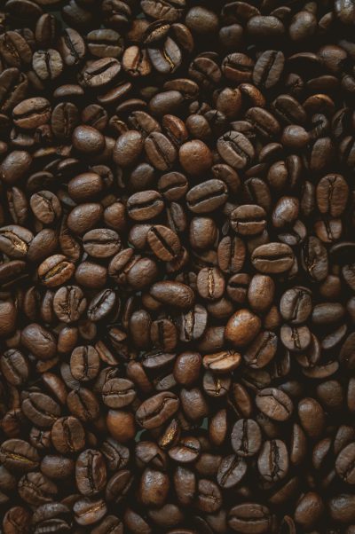 close up of coffee beans, dark background, product photography, studio lighting, high resolution photography, hyper realistic, detailed texture, commercial imagery, professional color grading, cinematic film grain, canon eos r5 --ar 85:128