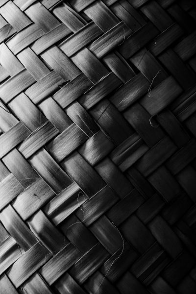 Black and white photography of a bamboo basket's texture, in a minimalist style. The photograph captures the texture of the basket in a minimalist, monochrome style that emphasizes simplicity and negative space. --ar 85:128