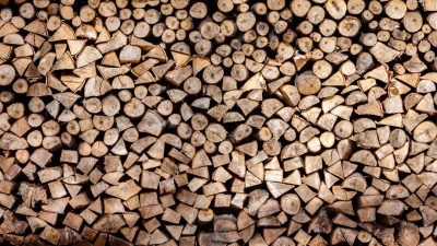 Background of stacked firewood for commercial use, perfect for design projects or branding visuals. The texture and pattern created by the wood sets an inviting tone in any setting. , stylish stock photo, clean sharp focus --ar 16:9