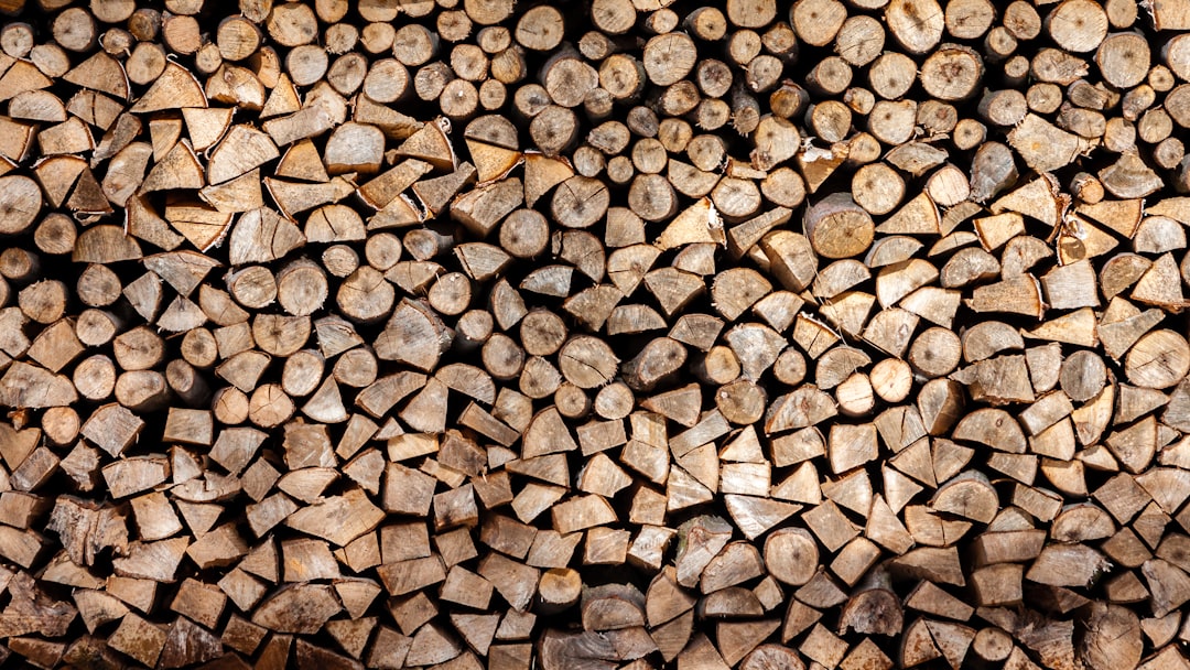 Background of stacked firewood for commercial use, perfect for design projects or branding visuals. The texture and pattern created by the wood sets an inviting tone in any setting. , stylish stock photo, clean sharp focus –ar 16:9