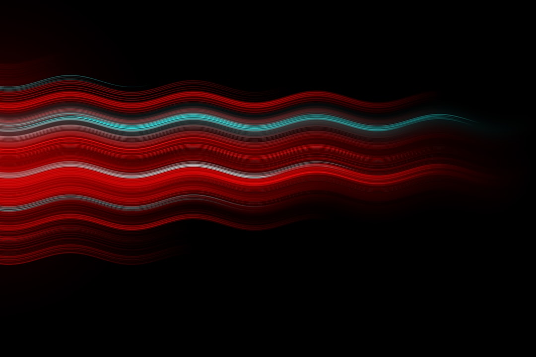 Red and cyan wavy lines on a black background, glowing light effects with a red gradient color and dark tones. A blurred effect with soft lighting in the vector illustration style of abstract art with smooth, minimalist lines and design. High resolution, high quality image.
