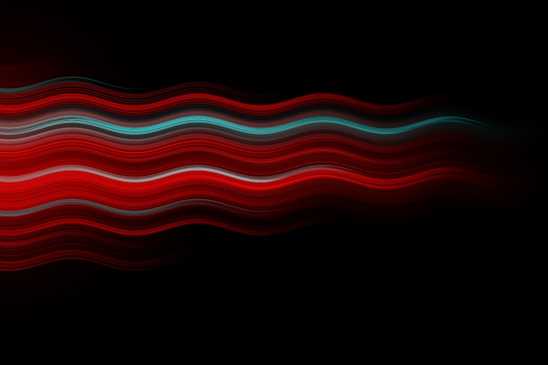 Red and cyan wavy lines on a black background, a vector illustration in the minimalist style with a symmetrical composition. Soft light and dynamic effects are used on abstract shapes with smooth curves. High resolution and high quality. –ar 128:85