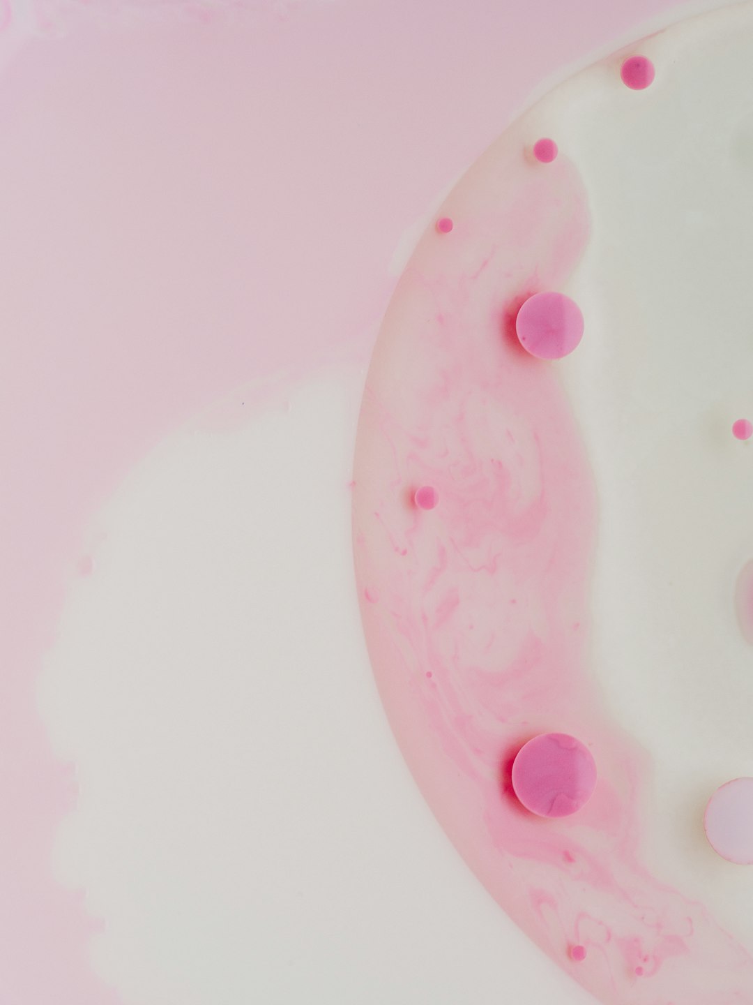 Pink and white pink circles on the surface of milk in an abstract form, creating circular shapes of different sizes, delicate textures, light tones, and a white background. A top view with macro photography using a macro lens under bright lighting to show delicate details with an artistic sense. in the style of –ar 3:4