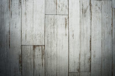 White wooden floor, distressed and weathered style, top view, closeup, texture background, high resolution photography, professional color grading, no contrast, clean sharp focus, soft shadows, hyper realistic --ar 128:85