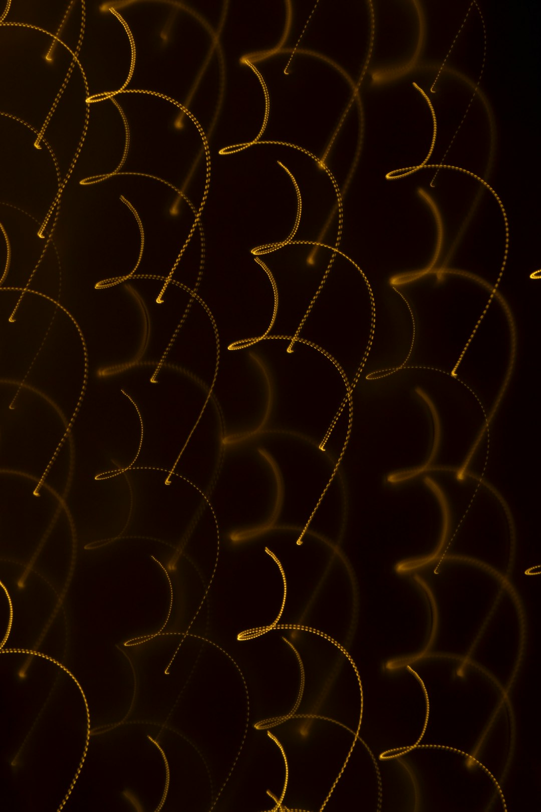 A background of golden lines on black, in the shape of circles and arches, with a dark brown gradient background, light painting, and glowing curves –ar 85:128