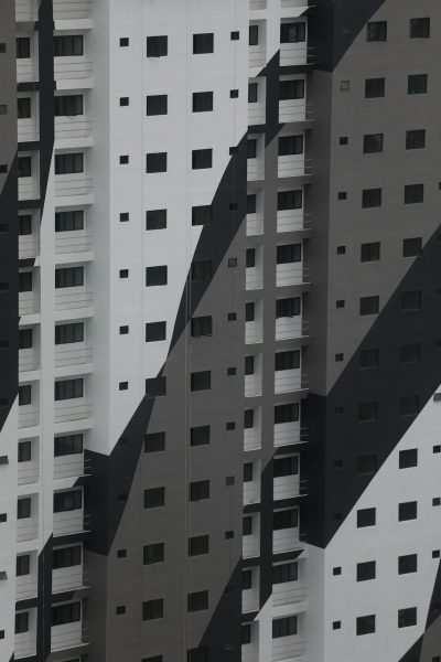 A photo of an abstract pattern composed of black and white apartment buildings in Singapore, geometric shapes, inspired in the style of architecture photography, hyper realistic. --ar 85:128