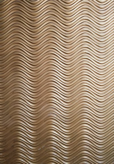 Photo of an abstract wood grain pattern on the wall, with curved lines creating wavy patterns. The light brown background has a textured surface that resembles carved wooden panels, in the style of wood panels. --ar 89:128