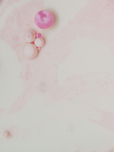 flat lay photo of pink and white marbled liquid with small round bubbles, pastel aesthetic, on light background, flatlay photography, dreamy, minimalistic, --ar 3:4