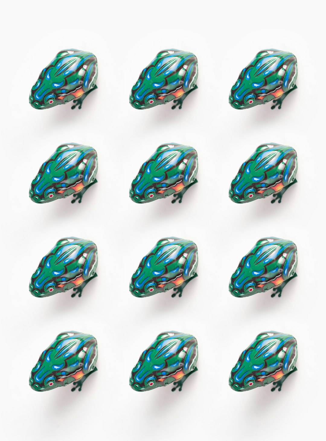 A grid of 9 metallic green and blue toad heads on a white background, in the style of [Hiroshi Nagai](https://goo.gl/search?artist%20Hiroshi%20Nagai), 2D flat illustration, simple. –ar 47:64