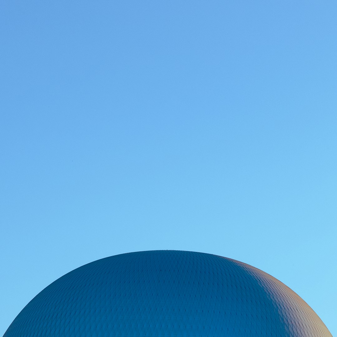 minimalist photo of blue dome, blue sky, centered, copy space for text, high resolution photography –ar 128:127