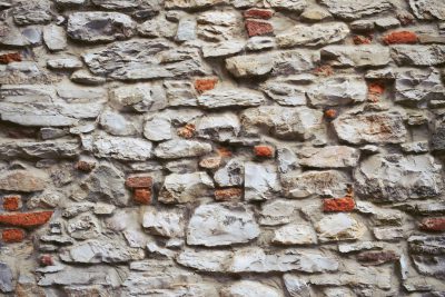 old stone wall background, texture of natural old grey rocks with red bricks in the style of natural textures. --ar 128:85