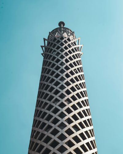 A closeup photo of the Doha atmospheric cloud lighthouse, made from interwoven steel mesh against a clear blue sky. The architecture is minimalist and modern with geometric patterns. High resolution, high detail, sharp focus. --ar 51:64