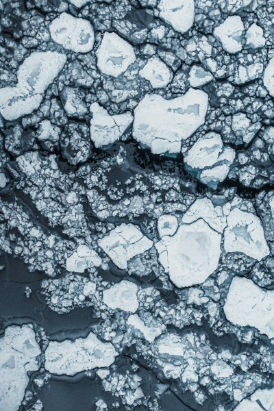 Aerial view of melting arctic ice, intricate details, texture --ar 85:128