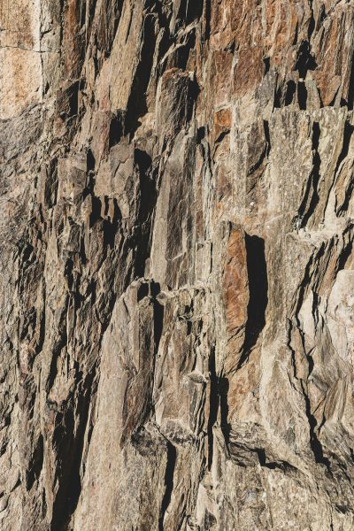 A closeup of the rugged, rocky surface of an alpine cliff in Patagonia.. Award winning photography, Realistic Photography --ar 85:128