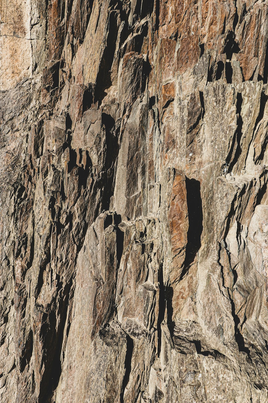 A closeup of the rugged, rocky surface of an alpine cliff in Patagonia.. Award winning photography, Realistic Photography –ar 85:128