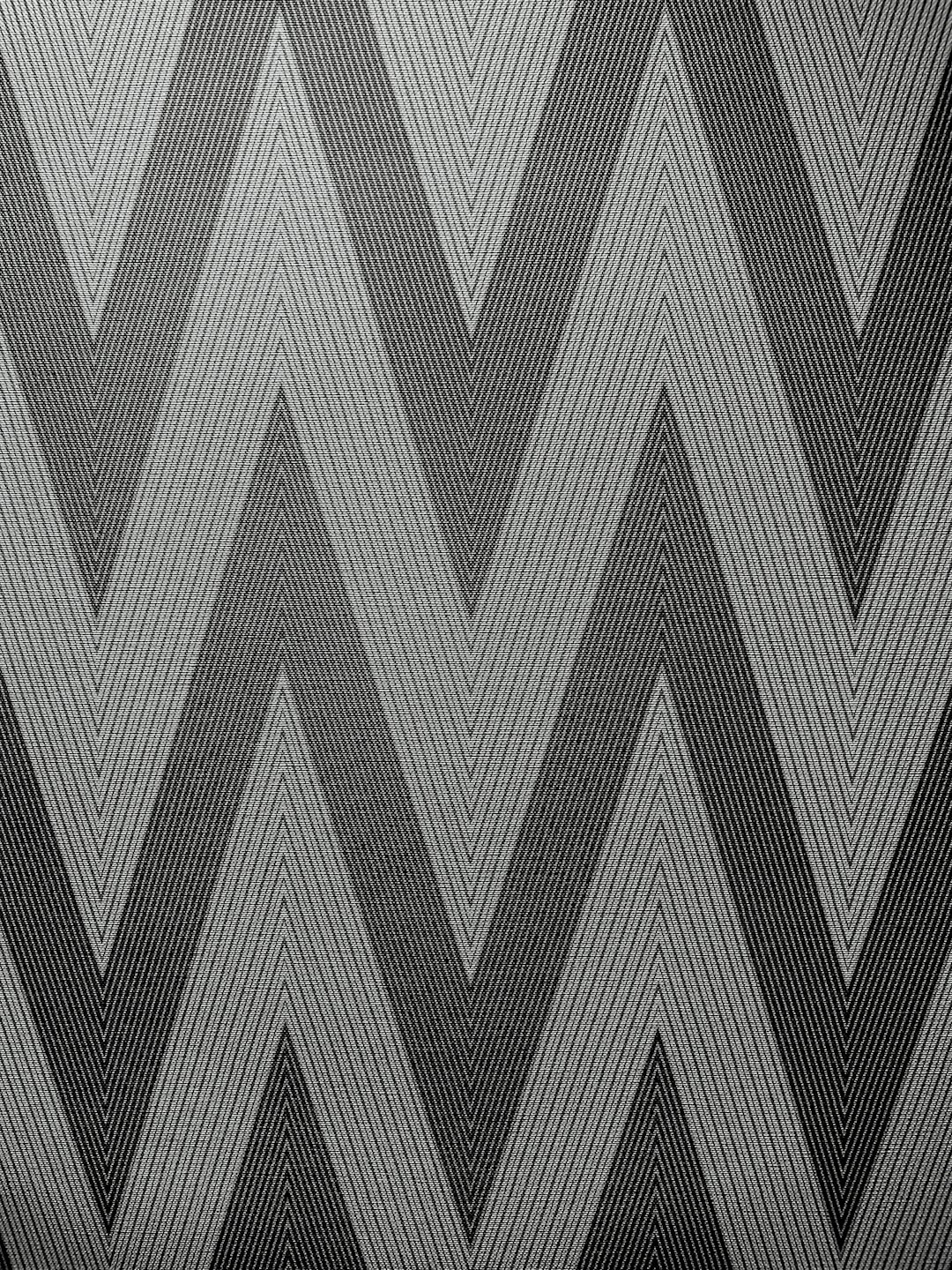 A grey and black zigzag pattern on the wall, in high resolution, high detail, and high quality. –ar 3:4