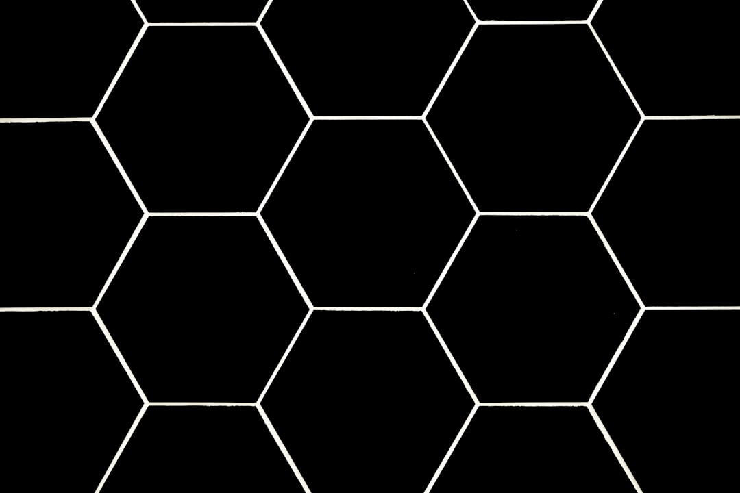 A seamless hexagon pattern, white outline on black background, simple and elegant design for a tile effect in the style of M.C., perfect for various applications where symmetrical geometric patterns can be used –ar 128:85