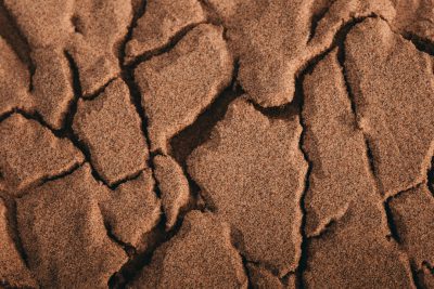 chocolate colored sand, cracks, top view, macro photography --ar 128:85