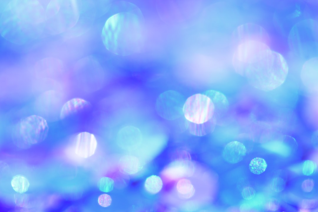 Blurred light blue and purple background with sparkling bubbles, creating an enchanting atmosphere for festive or special events. –ar 128:85