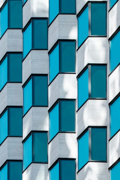 Detail of the facade of a modern building with blue and white patterned windows in the style of archdaily photography. --ar 85:128