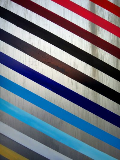 Closeup of horizontal stripes on the wall, silver background with red, blue, black, white and grey stripes, in the style of Edoardo Tavera. --ar 3:4