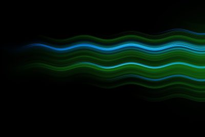 A single, thin wavy line of green and blue light on a black background. The line has an elegant quality with soft edges that give it depth. It seems to dance across the canvas while slightly undulating. There is no text or other elements in front of it. This design would be suitable for use as a background or wallpaper, combining simplicity with visual interest from its unique lighting effect. It could also represent a theme like water or energy flow in the style of unique lighting effect. --ar 128:85