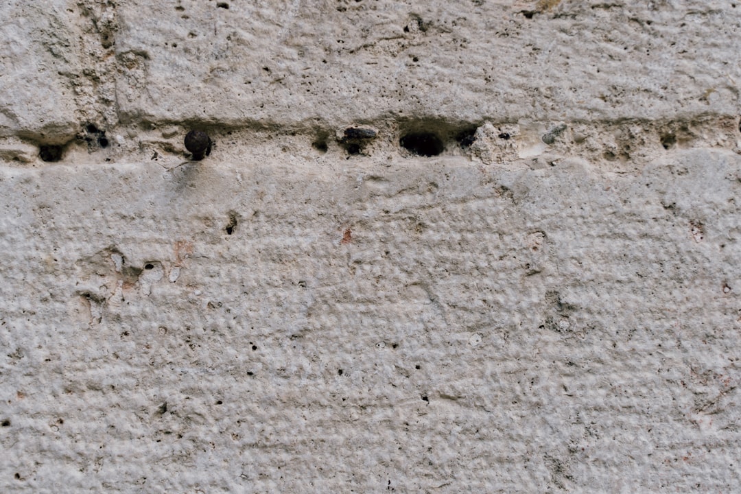 Closeup of small animal holes in the concrete wall, real photo –ar 128:85