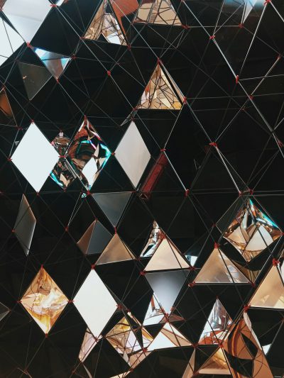 geometric structure made of black and silver triangles, mirror finish, shiny metal surface, hanging from ceiling, interior design photography, shot on leica m6 with portra film stock quality --ar 3:4