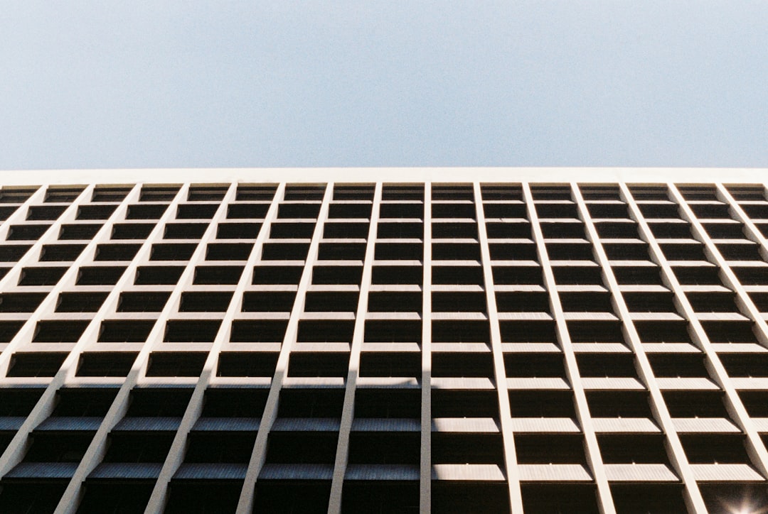 low angle photo of an office building facade, grid pattern on the side, daylight, shot with leica m6 and portra film stock, fujifilm superia –ar 128:85