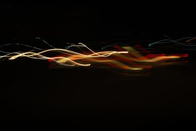 Light painting on black background, light trails, long exposure, red and yellow lines, slow shutter speed photography, soft focus, 2K, high resolution --ar 128:85