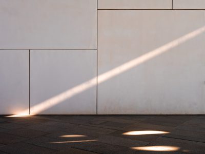 a white wall with a beam of light shining on it, the sun is setting and casting long shadows across an empty floor, modern architecture, architectural photography, architectural detail, detailed photography, cinematic --ar 4:3