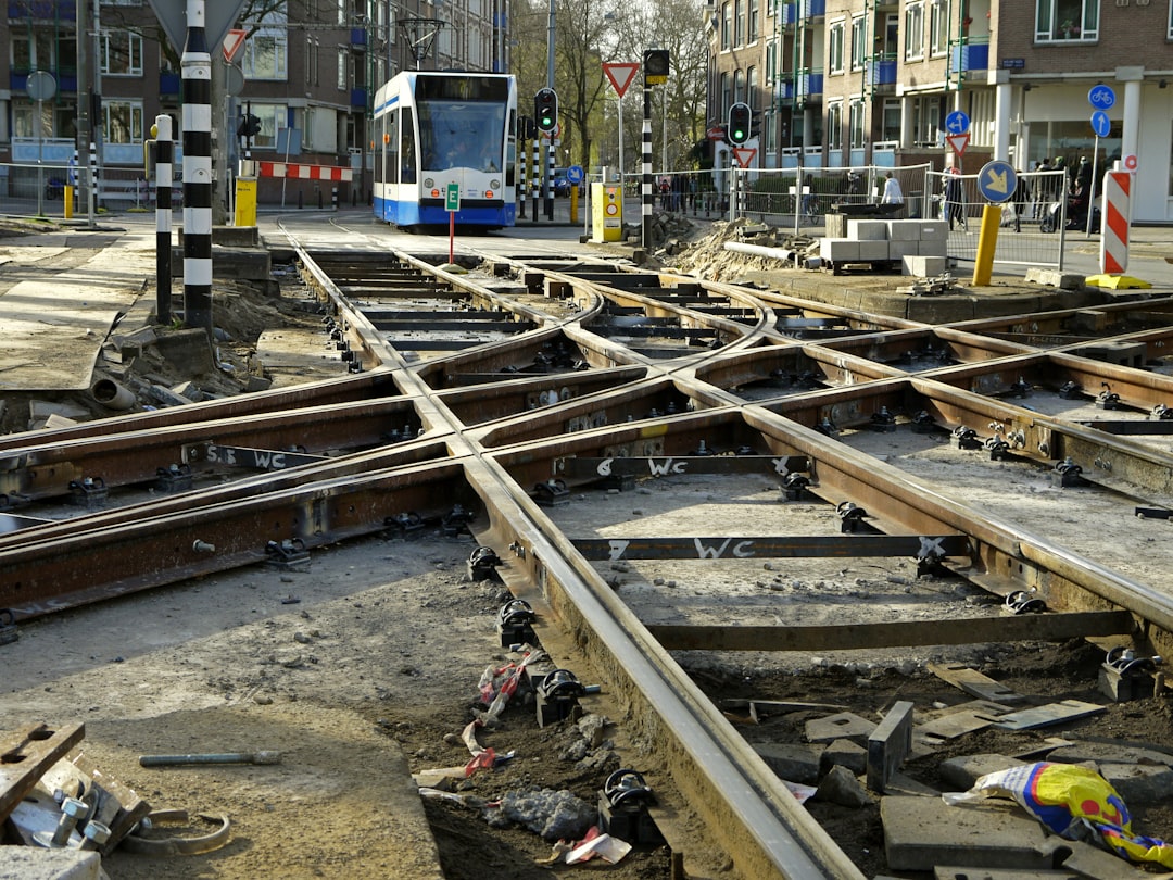 Dutch tram tracks broken and all over the place in amsterdam, with construction materials scattered around it, –ar 4:3