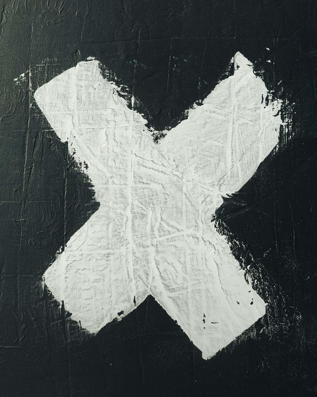 White X painted on black background, texture of the paper, simple and minimalistic, white x symbol, closeup, high resolution. The painting was done in the style of White X with a simple symbol on a textured black background. –ar 51:64