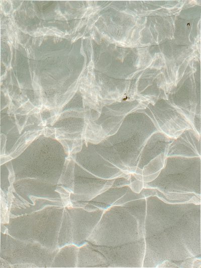 top down view of clear water, sand and light beams, subtle light colors, in the style of kodak film photography --ar 3:4